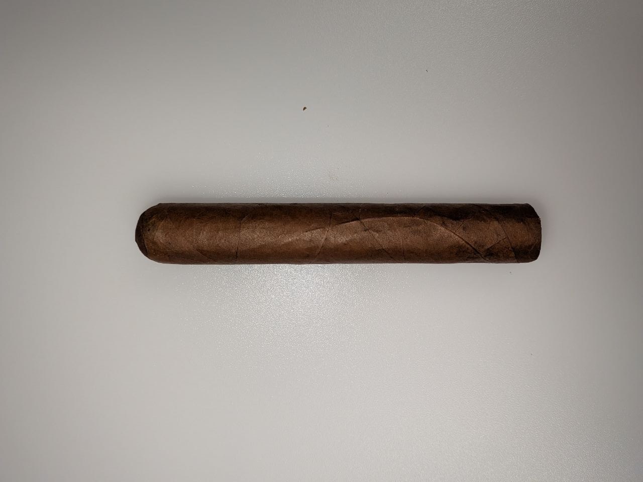Parejo cigar with straight sides, rounded cap, and flat foot.